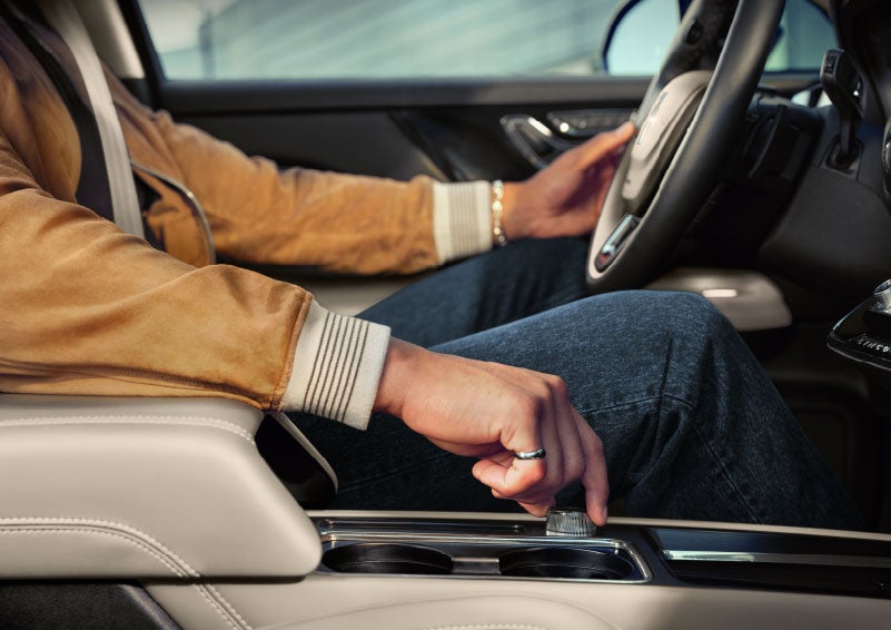 The driver of a 2024 Lincoln Corsair® SUV is shown selecting the drive mode. | Bill Knight Lincoln in Tulsa OK