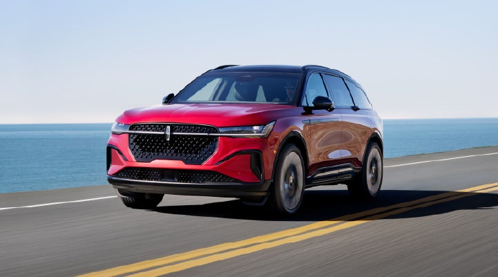 A 2025 Lincoln Nautilus® SUV is being driven on a seaside roadway. | Bill Knight Lincoln in Tulsa OK