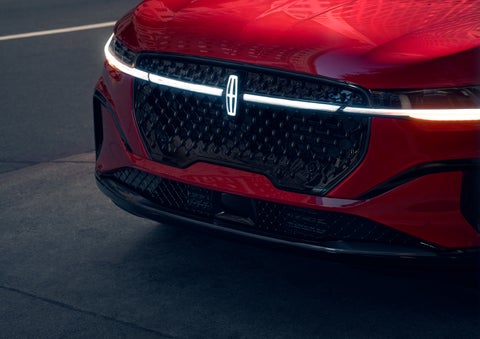 The available front LED light bar and center Lincoln Star logo glow at dusk. | Bill Knight Lincoln in Tulsa OK