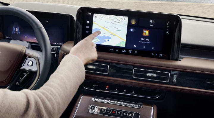 A person is tapping the center display touchscreen of a 2026 Lincoln Aviator® SUV. | Bill Knight Lincoln in Tulsa OK