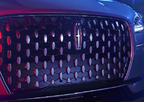 The grille of a 2025 Lincoln Corsair&reg; SUV reflects neon light at night. | Bill Knight Lincoln in Tulsa OK