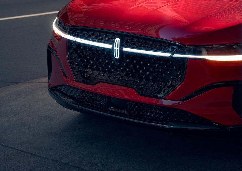 The available front LED light bar and center Lincoln Star logo glow at dusk. | Bill Knight Lincoln in Tulsa OK