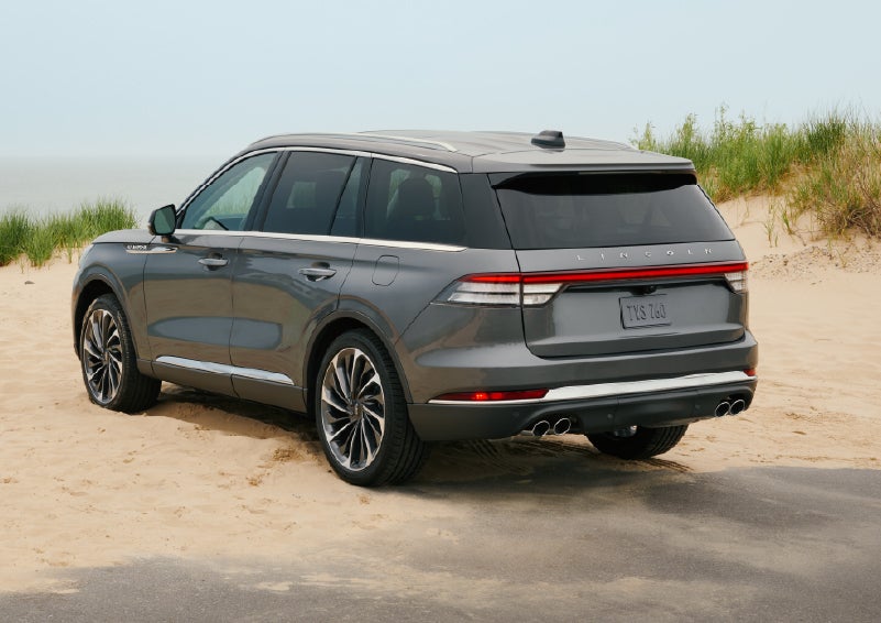 A 2027 Lincoln Aviator® SUV is parked next to sand dunes. | Bill Knight Lincoln in Tulsa OK