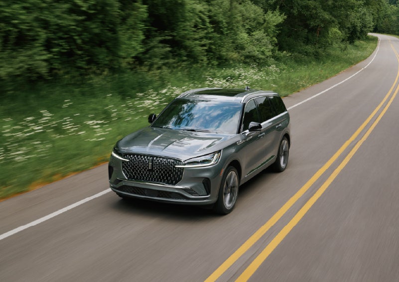 A 2027 Lincoln Aviator® SUV is being driven down a road. | Bill Knight Lincoln in Tulsa OK