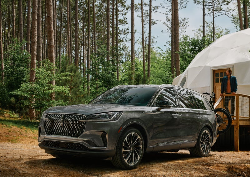 A 2027 Lincoln Aviator® is parked next to a high end glamping site. | Bill Knight Lincoln in Tulsa OK