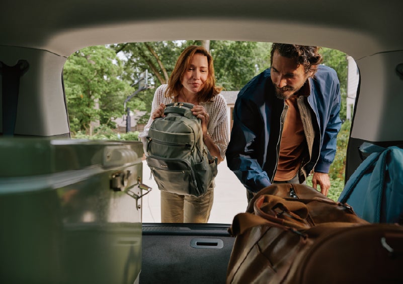 A couple loads luggage into the rear of a 2027 Lincoln Aviator® Black Label™ SUV..e 202 | Bill Knight Lincoln in Tulsa OK