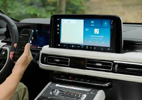 A person pairs thier phone with the center touchscreen of a 2027 Lincoln Aviator® Black Label™ SUV | Bill Knight Lincoln in Tulsa OK